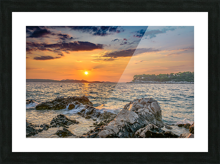 Sunset over rocky beach Picture Frame print