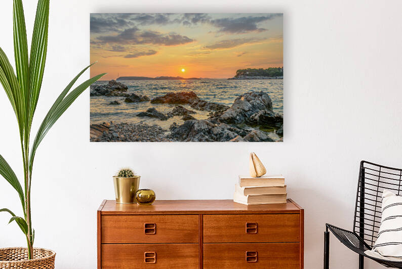 Sunset over rocky beach by Vedad Ceric
