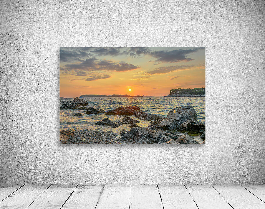 Sunset over rocky beach Wall Preview