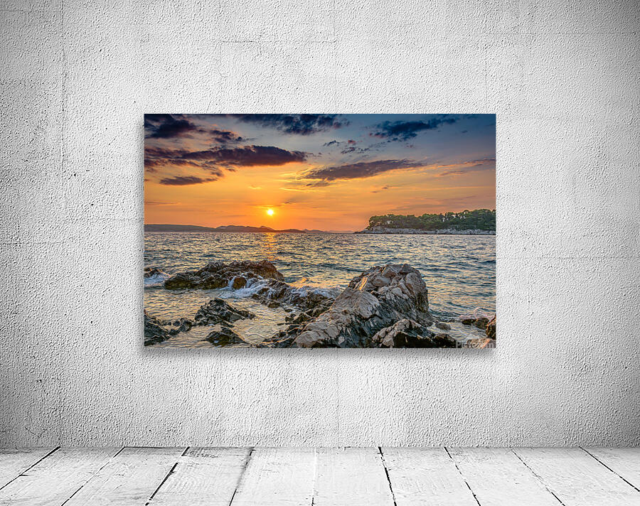 Sunset over rocky beach Wall Preview