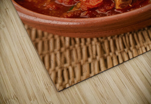 A rustic setting with a clay bowl containing a ri Romeu Hurmuzache puzzle