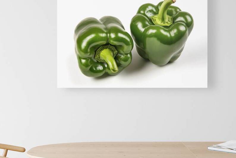 Two vibrant green bell peppers placed side by sid by Romeu Hurmuzache