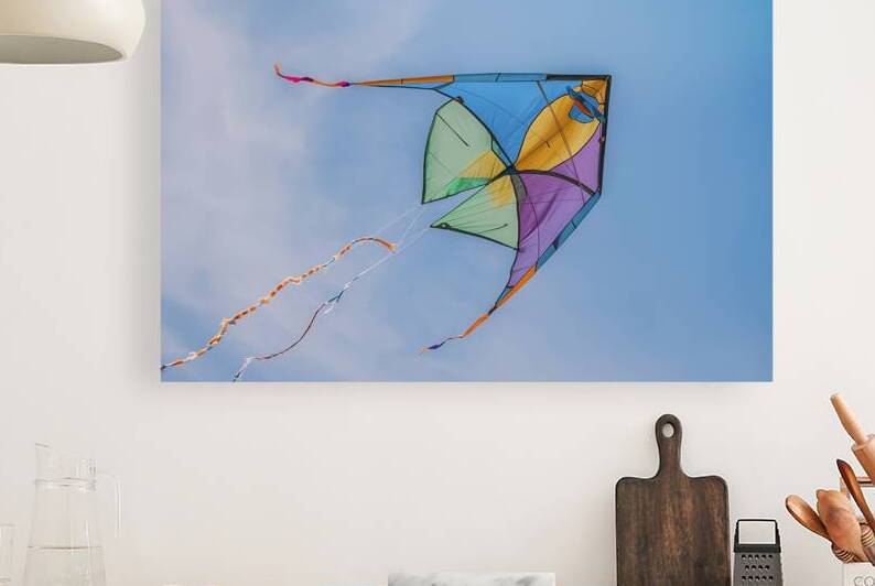 A colorful kite soaring in a clear blue sky 3 by Romeu Hurmuzache