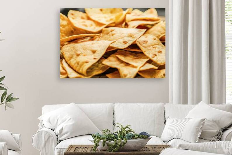 A close up view of tortilla chips with a golden b by Romeu Hurmuzache