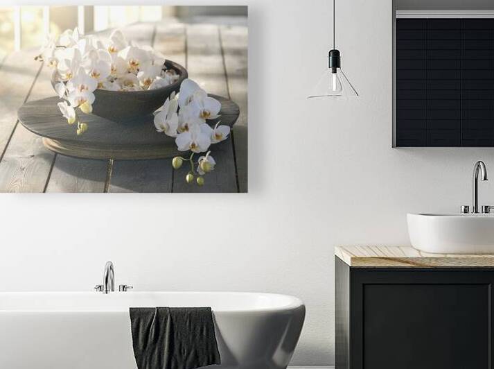 A serene setting with a dark wooden bowl containi by Romeu Hurmuzache