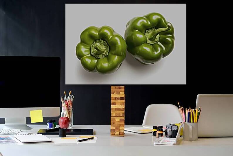 Two vibrant green bell peppers placed side by sid by Romeu Hurmuzache