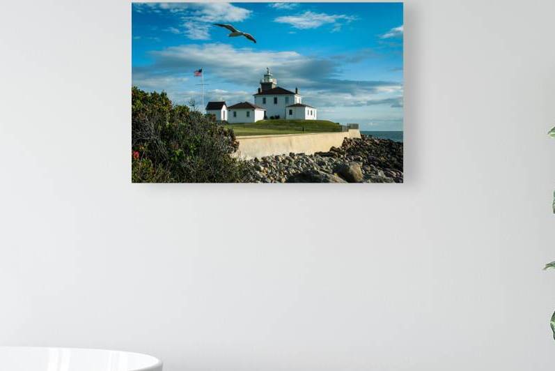 Seagull Flies Near Watch Hill Lighthouse in Rhode Island by Allan Wood