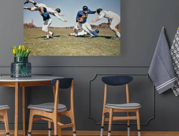 1964 FOOTBALL PLAYER WITH BALL FENDING OFF TACKLES 192594 by Panoramic Images