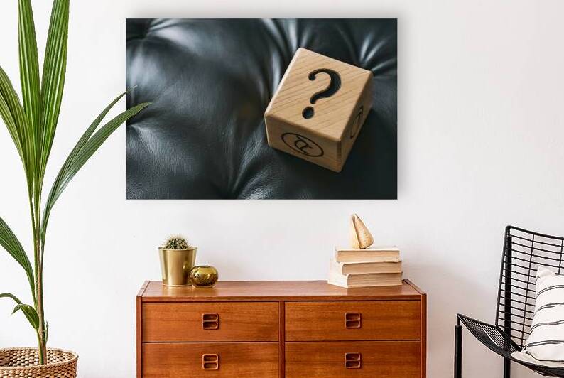 Wooden cube on black leather with question mark p by Marius Tomus