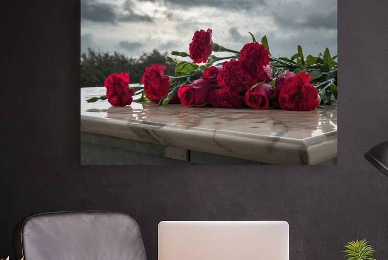 Red carnation flowers and roses are laid on a mar by Marius Tomus