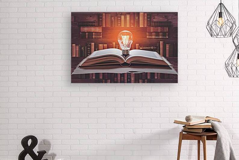 Open book with light bulb and hardback books on w by Marius Tomus