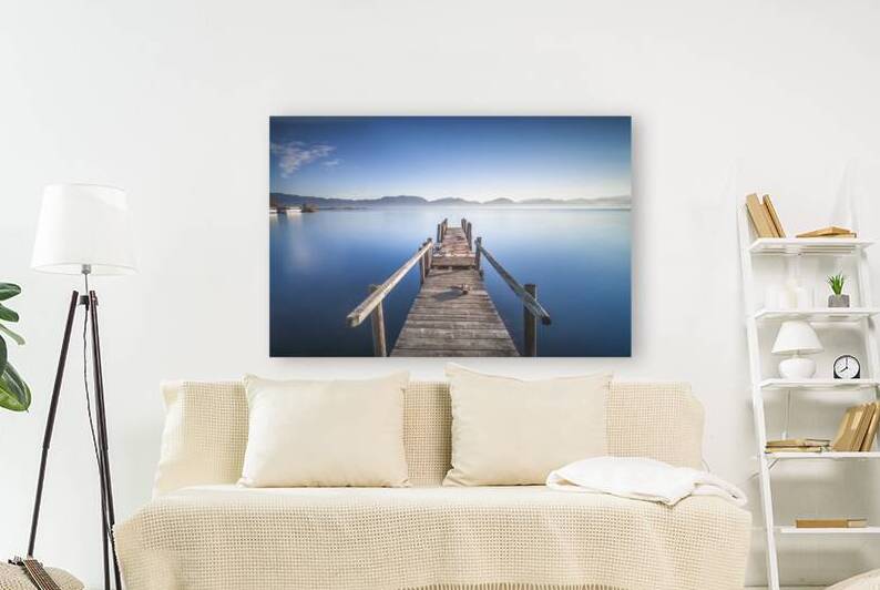Wooden jetty on the lake at sunrise. Lake Massaciuccoli. Italy by Stefano Orazzini