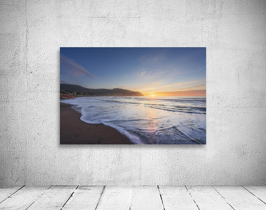 Waves on the Baratti beach at sunset. Tuscany Italy Wall Preview