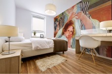 Young mother sewing Mural print