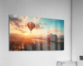 Colorful hot air balloon rises above grassy field with suitcase at sunset Acrylic Print