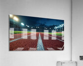 View of a well lit athletic track at night showcasing vibrant red surface and brightly illuminated surroundings Acrylic Print