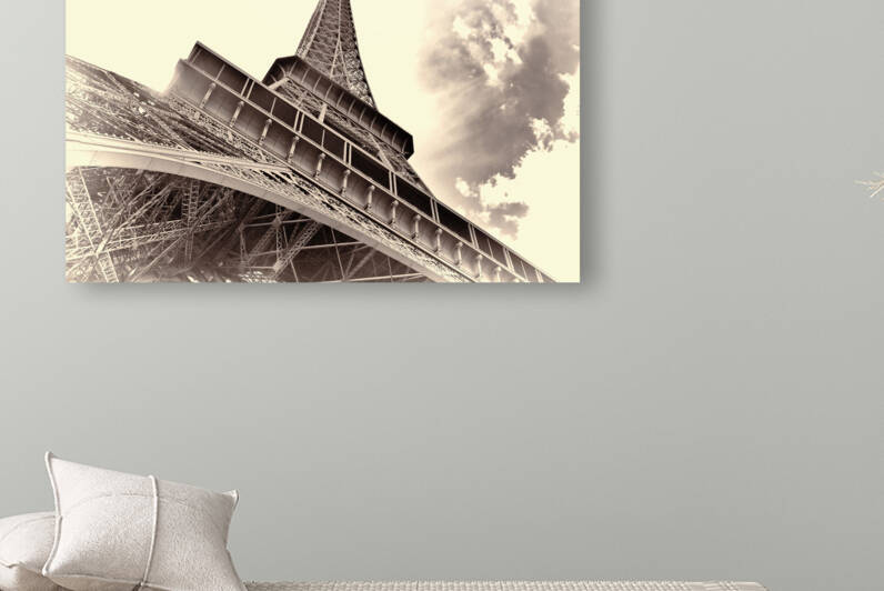 Eiffel Tower under a dramatic cloudy sky in Paris. by IB Photography