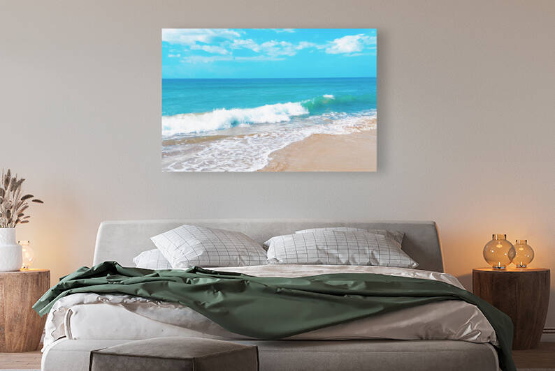 Captivating view of waves crashing onto the sandy beach under a vibrant blue sky. by IB Photography