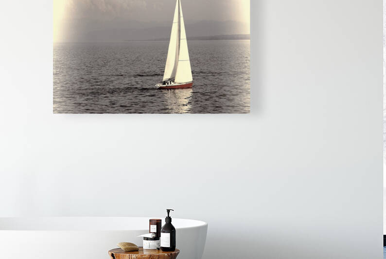 Sailboat with red hull glides across calm waters on a sunny serene day. by IB Photography