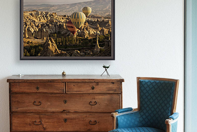 Hot air balloon flying over rock landscape at Cappadocia Turkey by MIRICA DAN-ALEXANDRU