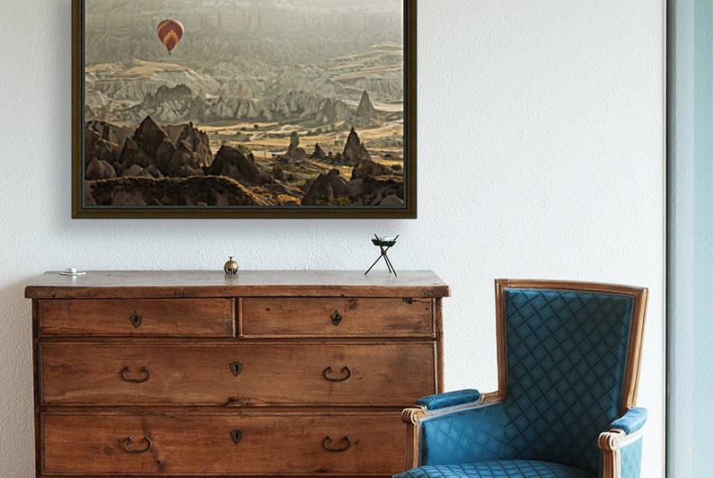 Hot air balloon flying over rock landscape at Cappadocia Turkey by MIRICA DAN-ALEXANDRU
