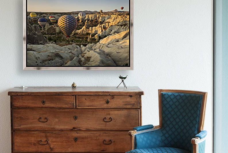 Hot air balloon flying over rock landscape at Cappadocia Turkey by MIRICA DAN-ALEXANDRU