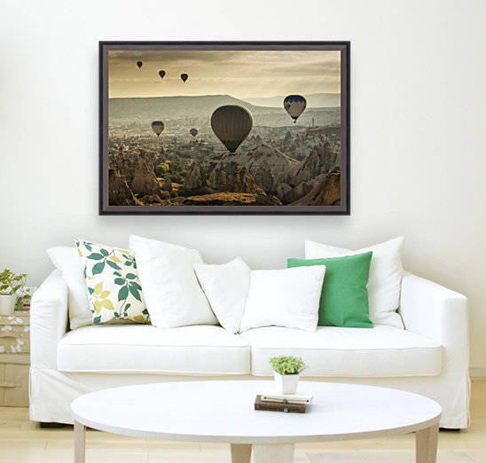 Hot air balloon flying over rock landscape at Cappadocia Turkey by MIRICA DAN-ALEXANDRU