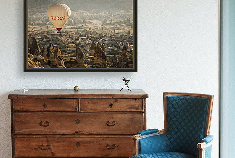 Hot air balloon flying over rock landscape at Cappadocia Turkey by MIRICA DAN-ALEXANDRU