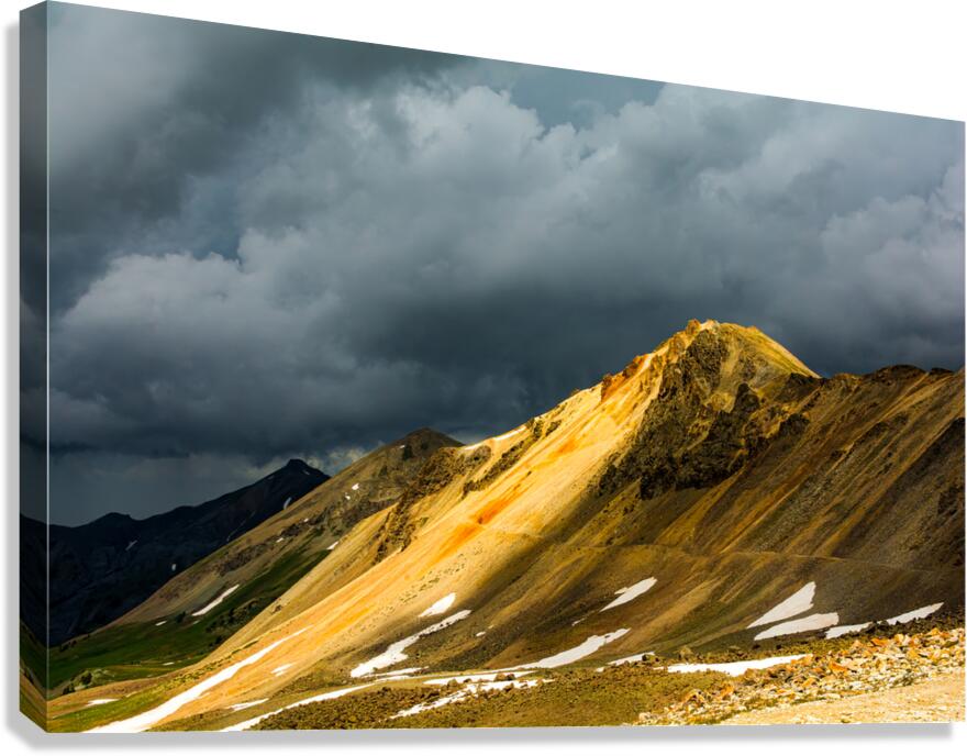 A Streak Of Light On Mountainside Through Stormy Clouds