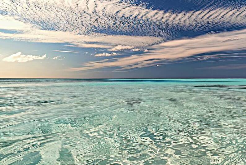 Clear sea with white cloudy and blue sky 4 by Liviu Ghitun