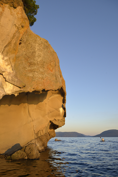 Sea kayaking under sculpted sandstone cliffs Digital Download