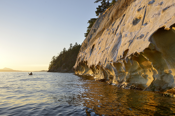 Sea kayaking under the sculpted sandstone cliffs Digital Download