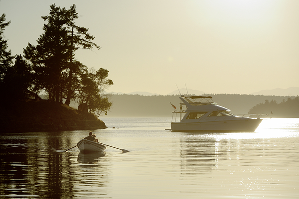 Couple in a dinghy rowing in front of a pleasure motorboat Digital Download