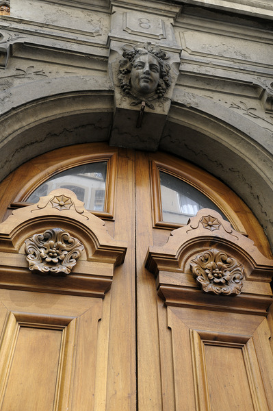 Wooden door with carved figurine in stone above it. France Digital Download