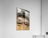 Wooden door with carved figurine in stone above it. France Acrylic Print
