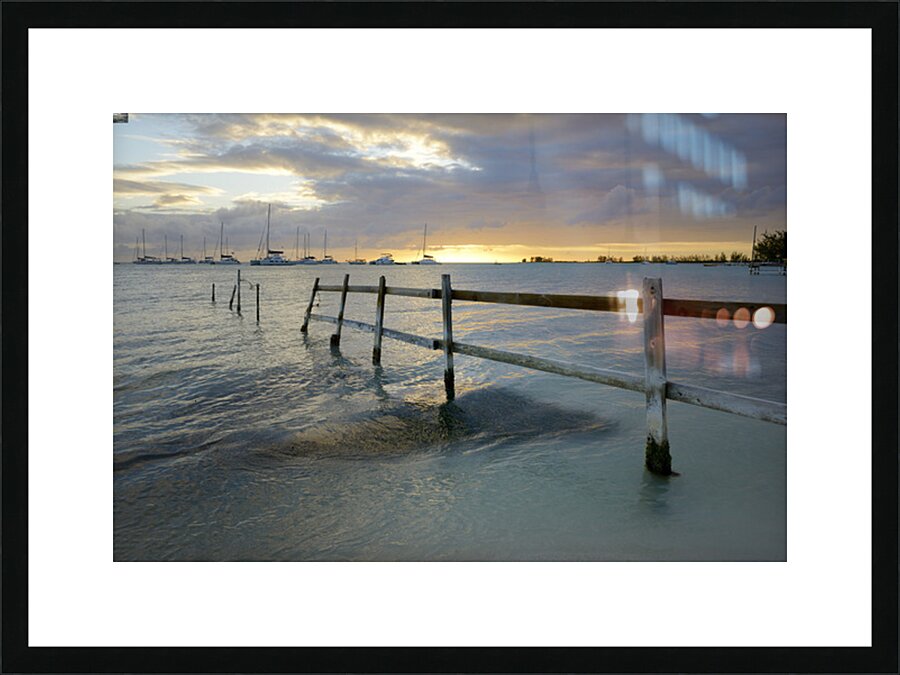 Old fence running into the ocean Picture Frame print