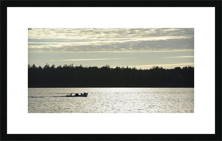 Backlit small boat coming into Tofino Picture Frame print