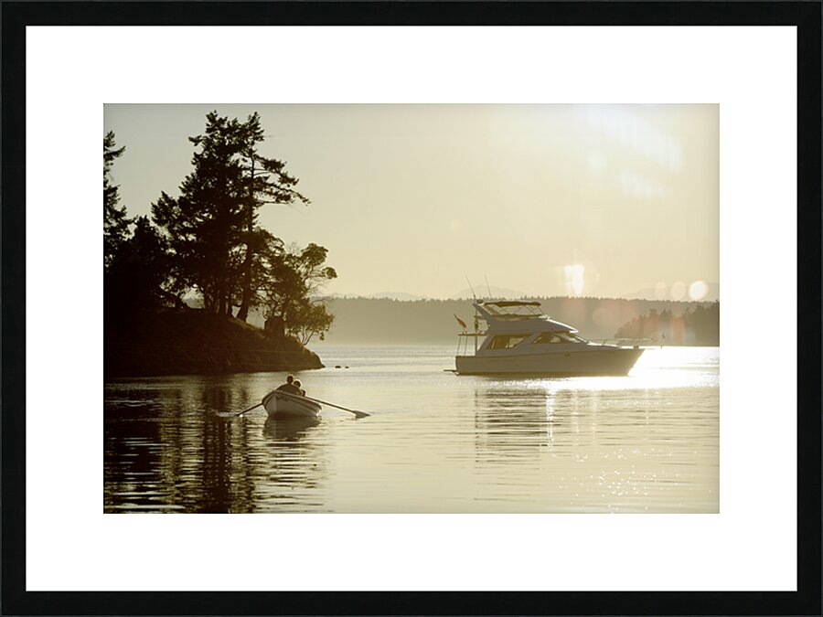 Couple in a dinghy rowing in front of a pleasure motorboat Picture Frame print