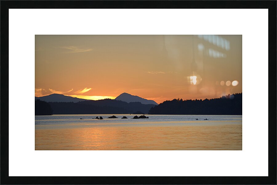 Kayakers near islets at the entrance to Princess Bay Picture Frame print
