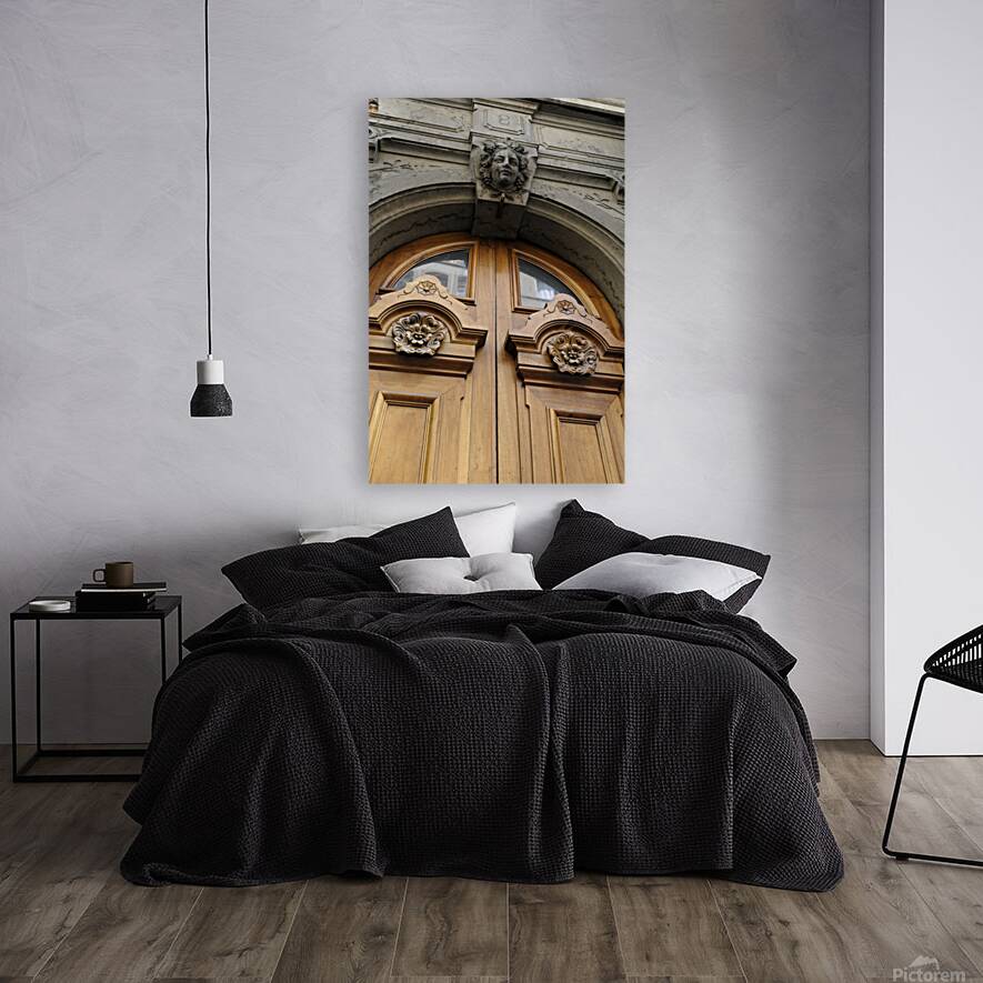 Wooden door with carved figurine in stone above it. France Reproduction