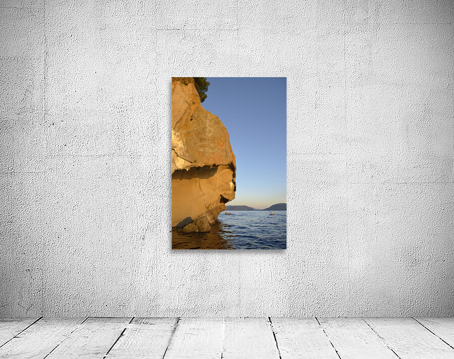 Sea kayaking under sculpted sandstone cliffs Wall Preview