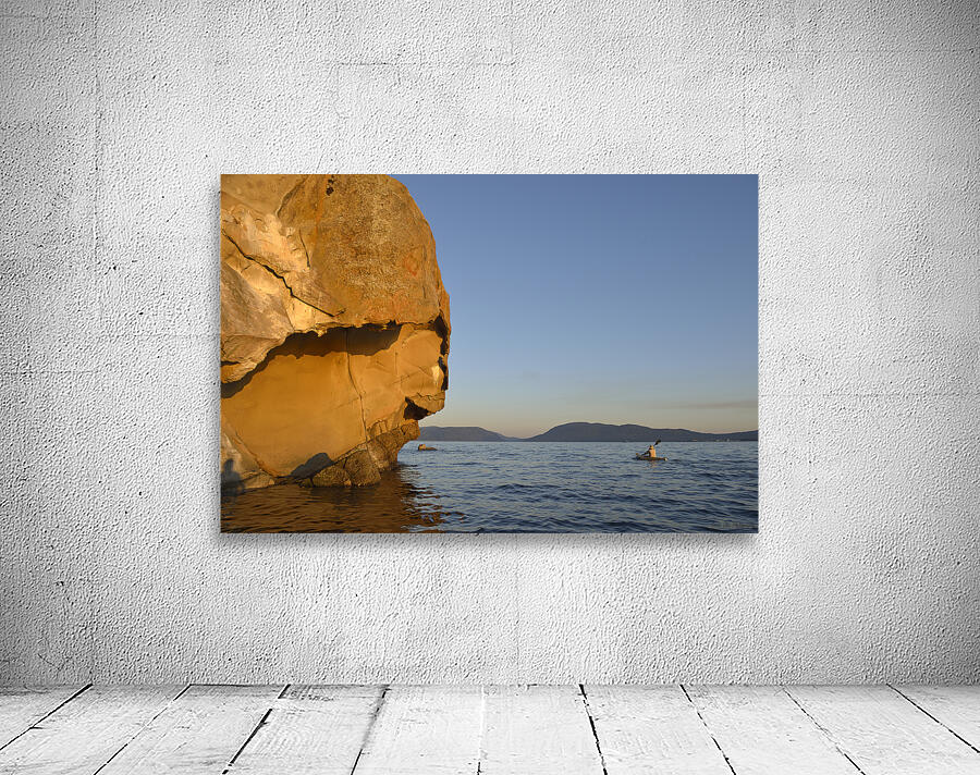 Sea kayaking under sculpted sandstone cliffs Wall Preview