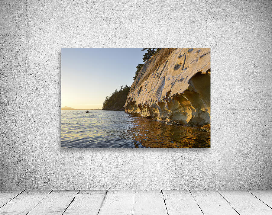 Sea kayaking under the sculpted sandstone cliffs Wall Preview