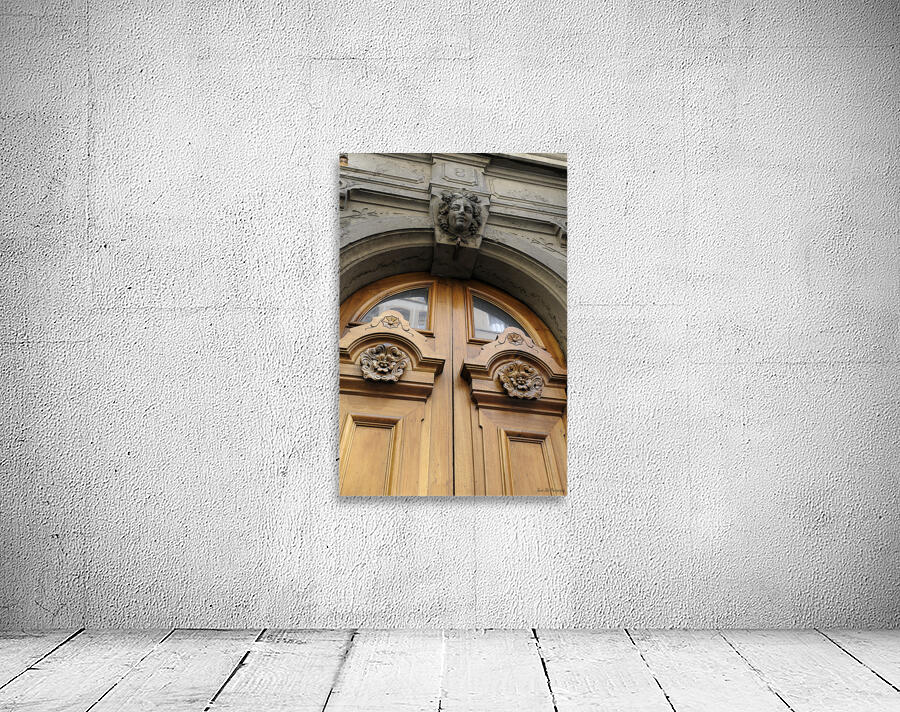 Wooden door with carved figurine in stone above it. France Wall Preview