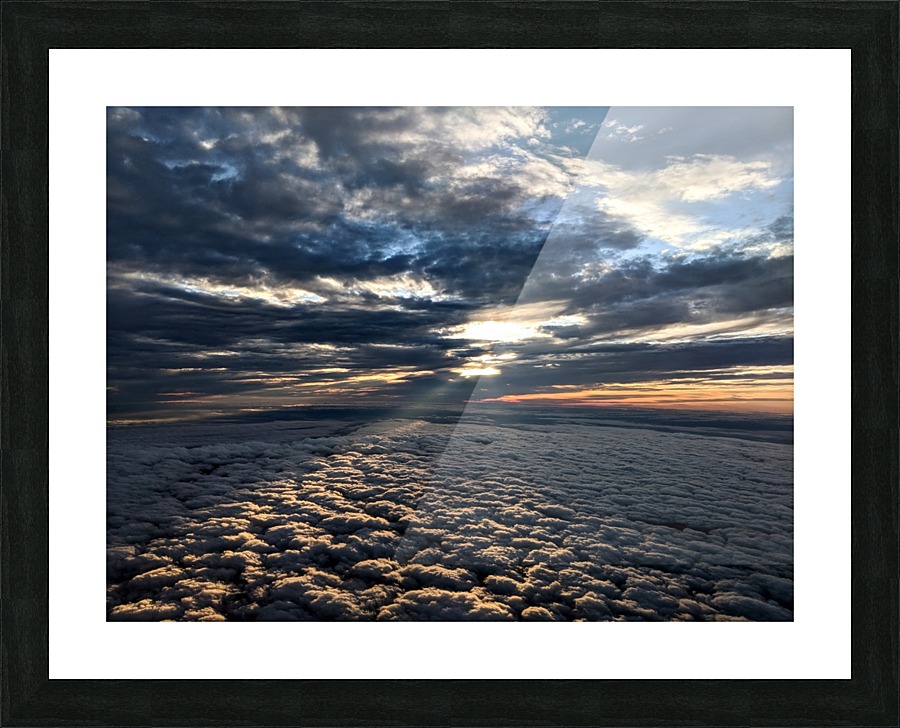 Light peering down upon the clouds Picture Frame print