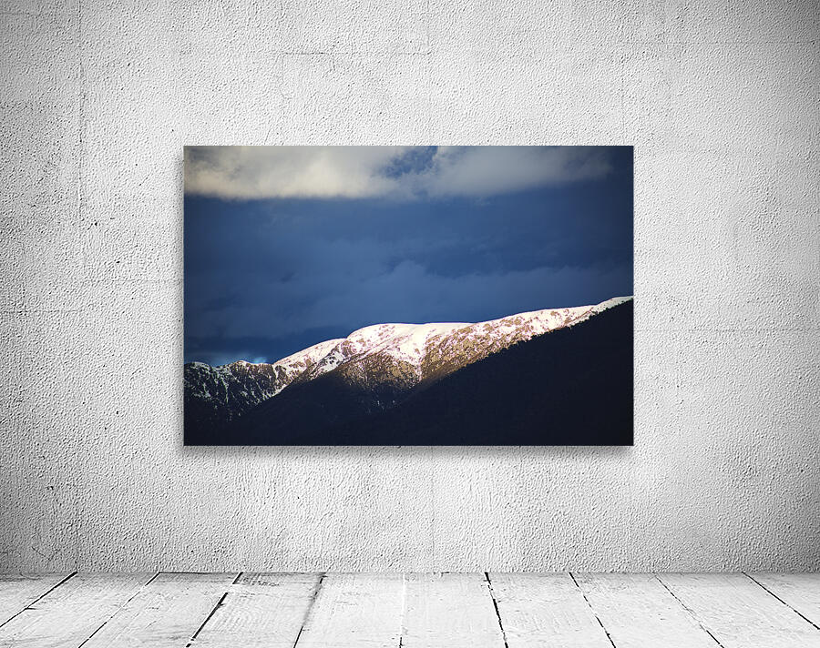 Sunlit Mountain With Dark Clouds Wall Preview