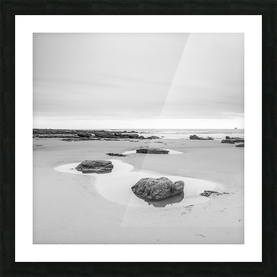 Rock pools on a sandy beach Picture Frame print