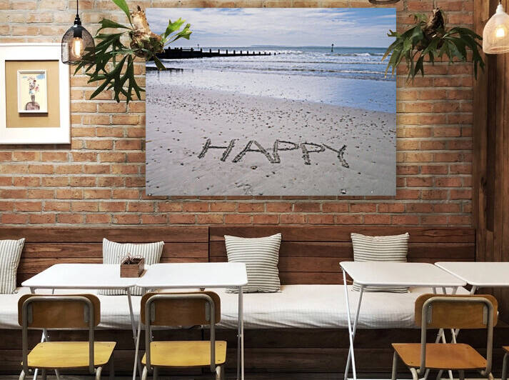 HAPPY" message written in smooth sand at the beach" by Assaf Frank