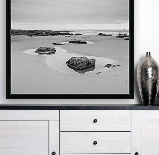 Rock pools on a sandy beach by Assaf Frank