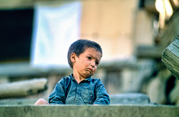 Sad boy sitting on stairs in Lahore Pakistan during the day Digital Download